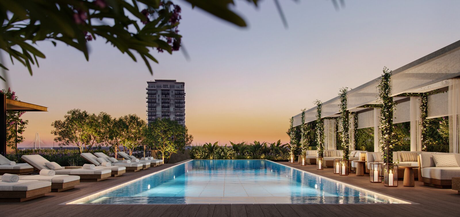 Resident pool deck with landscaped lounge areas at dusk