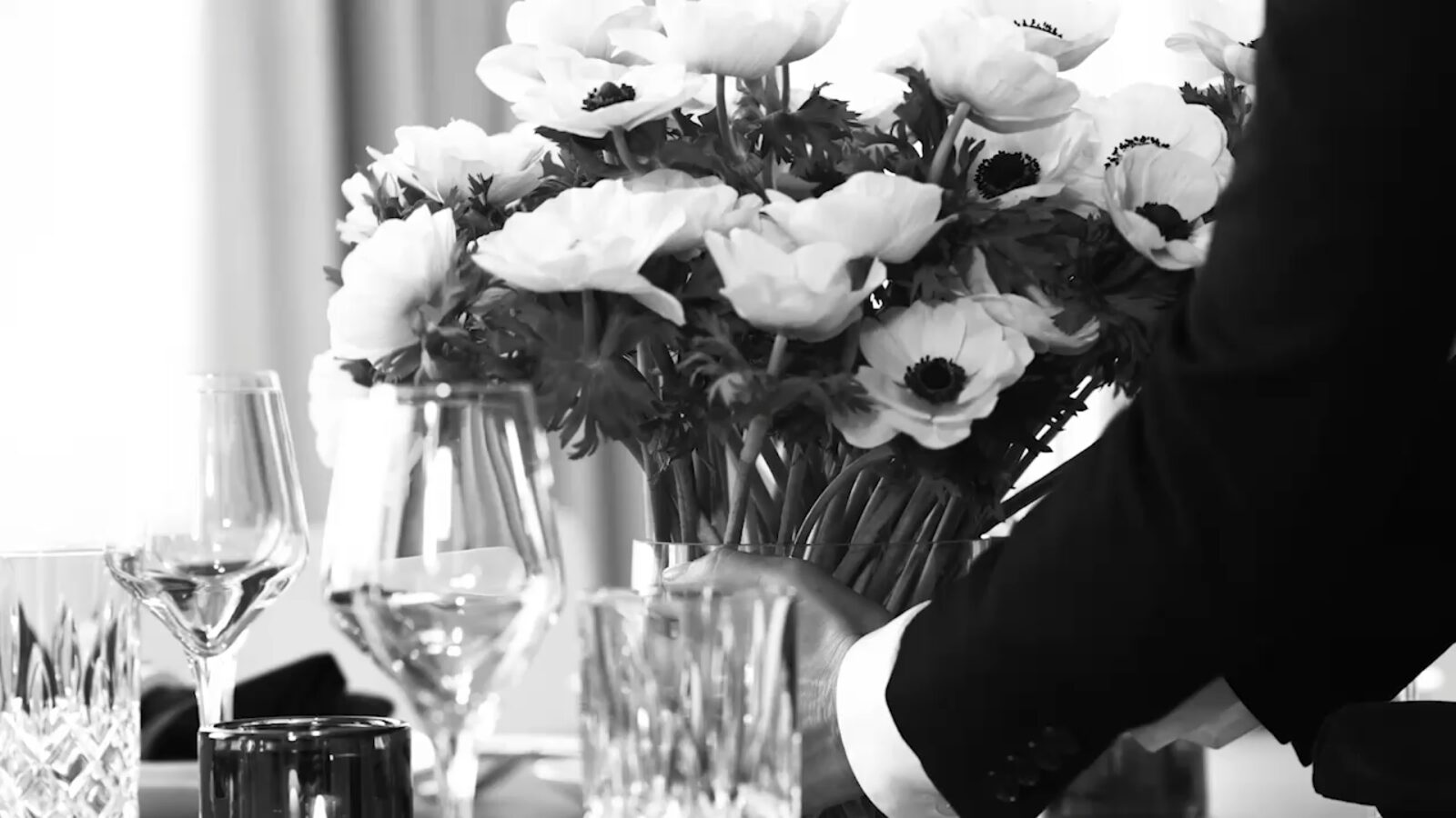 A table set for EDITION hospitality with a floral arrangement