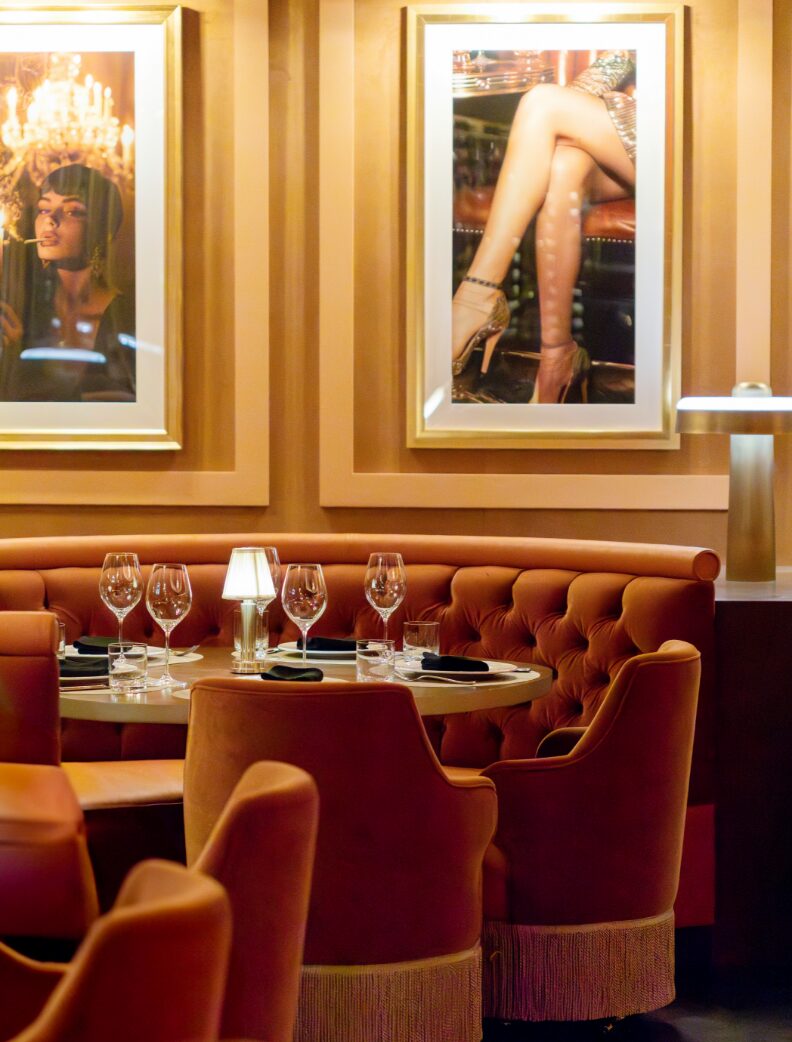 Intimate restaurant booth surrounded by framed art